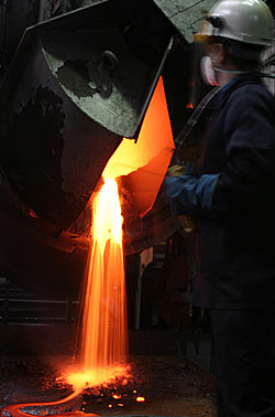 Cupellation furnace pouring litharge (Lead oxide).
