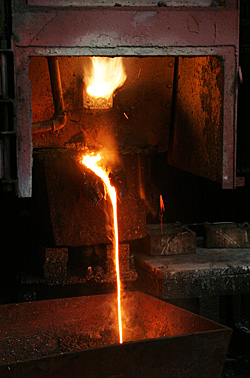 Blast furnace smelting of silver bearing materials producing lead-silver bullion and slag.